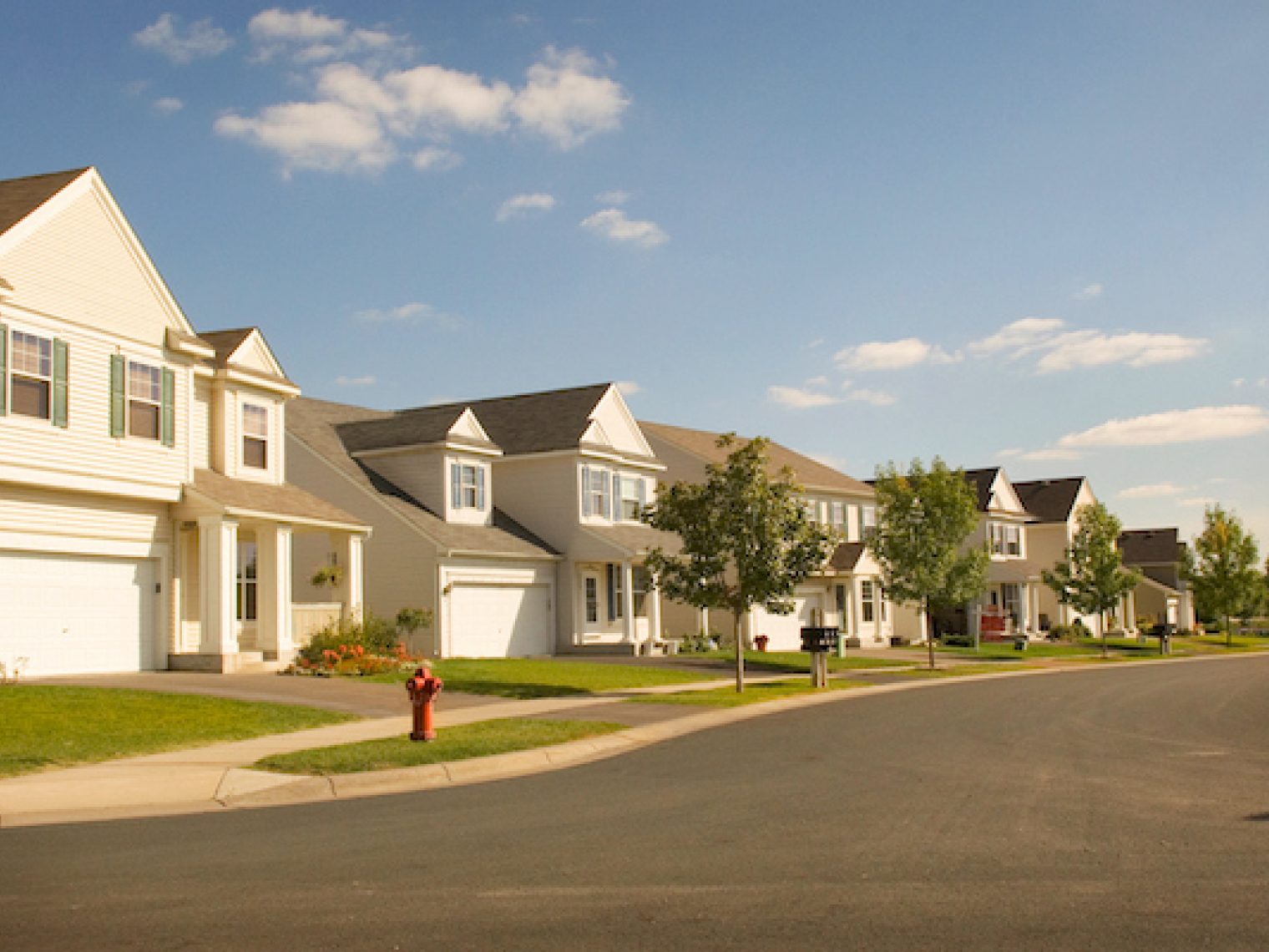 A suburban street full of houses.