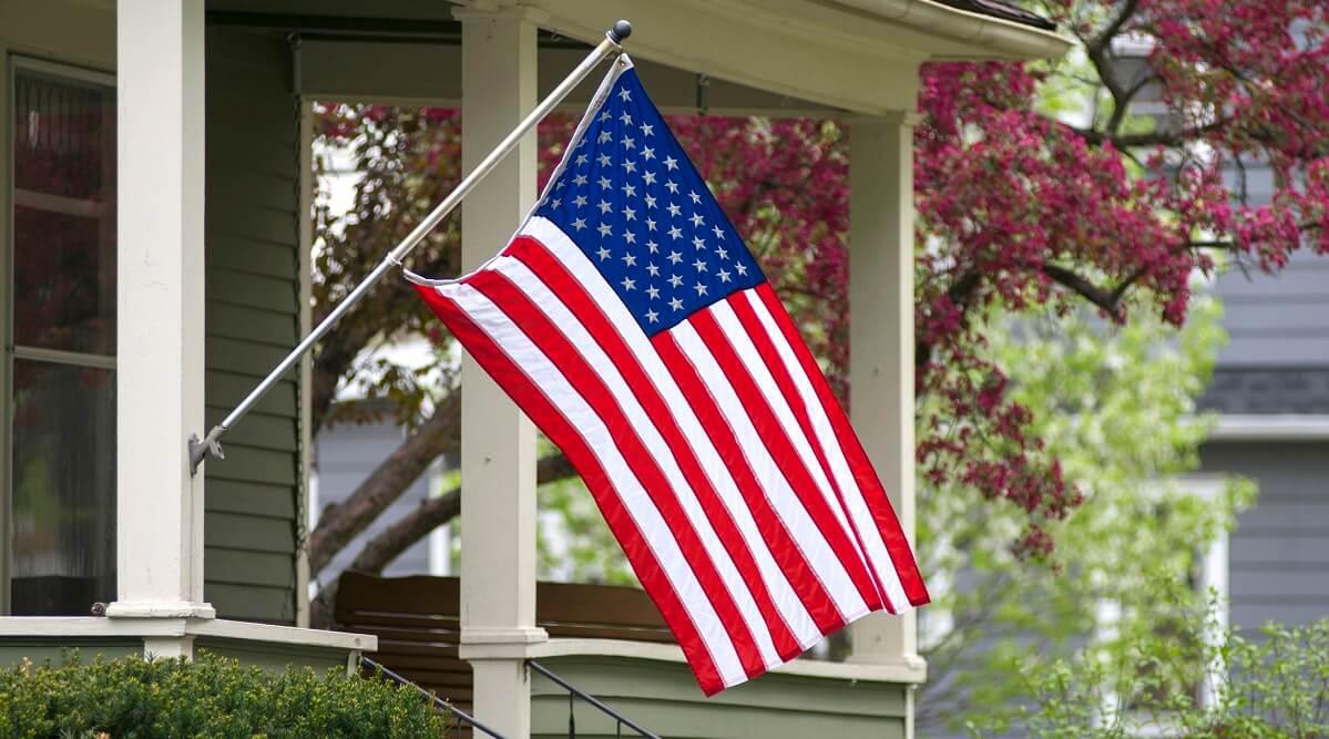 House with an American flag in front of it.