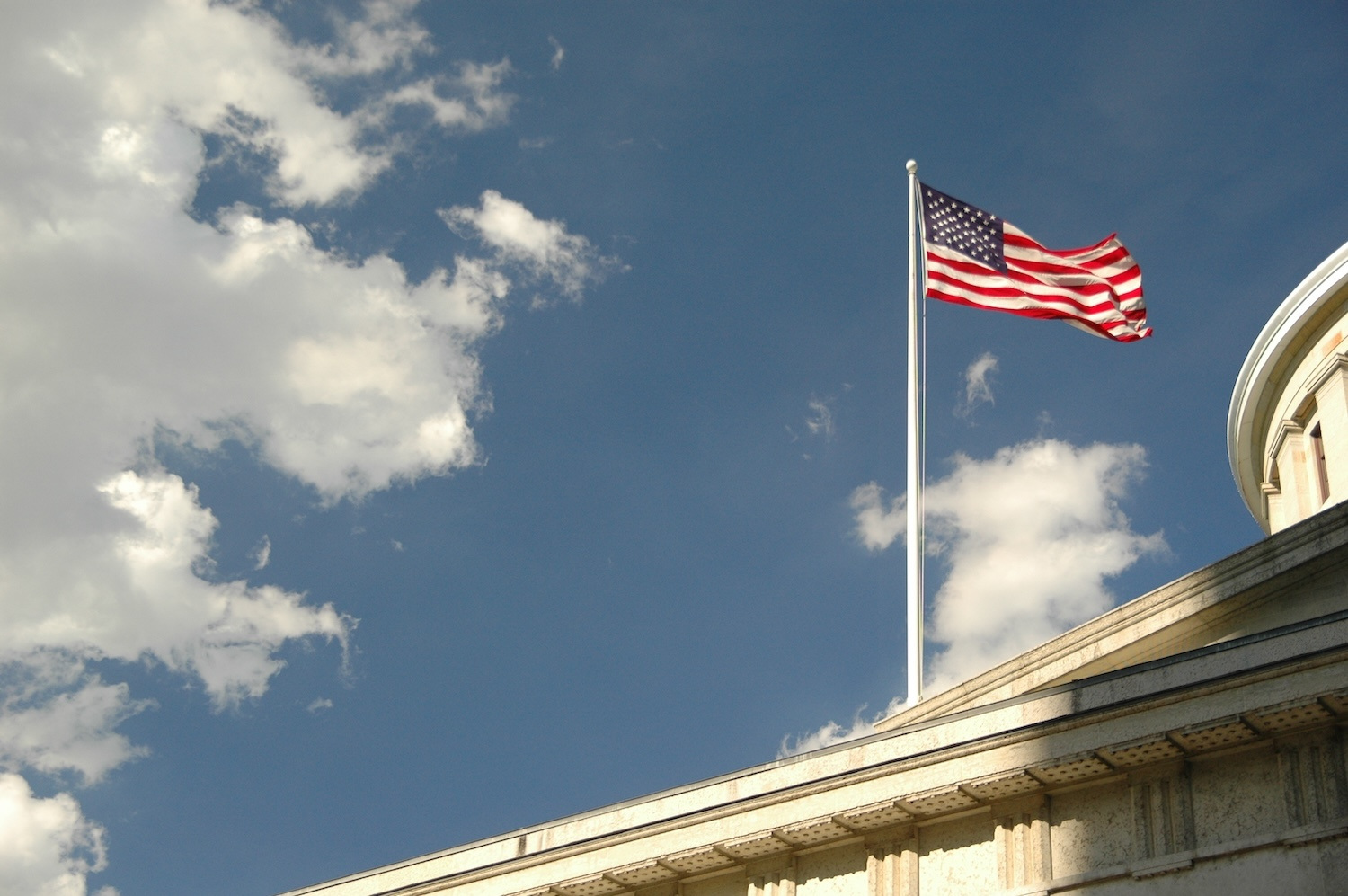 Exterior of a city building with an American flag on it.